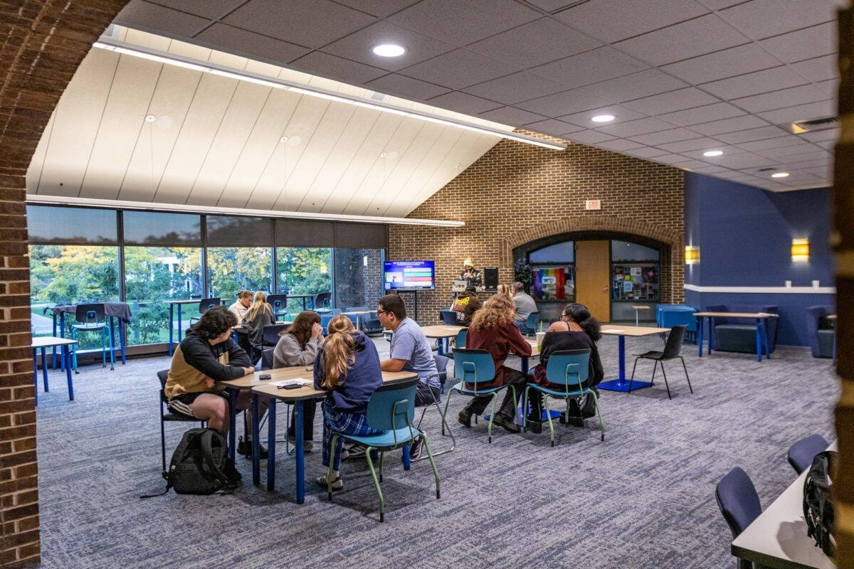Grand Valley Students sitting in Kirkhof Lobby, playing trivia